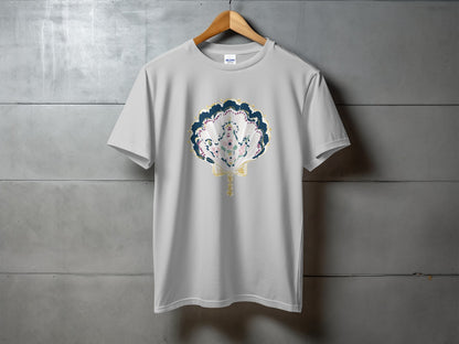 White t-shirt with a seashell design featuring blue, pink, and green accents.