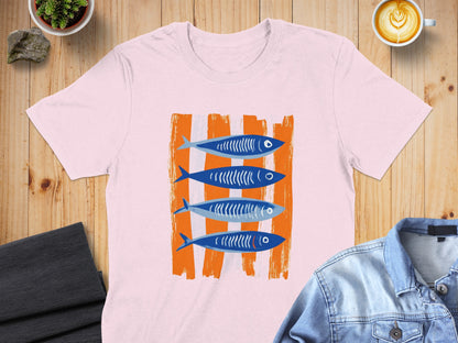Pink t-shirt with four blue, stylized fish on orange striped background.