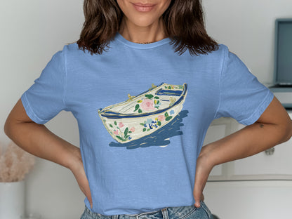 Light blue t-shirt with a watercolor floral boat illustration.