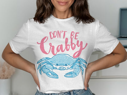White t-shirt with cartoon blue crab and text "Don't Be Crabby".