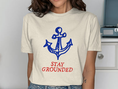 Cream t-shirt with blue anchor graphic and red "STAY GROUNDED" text.