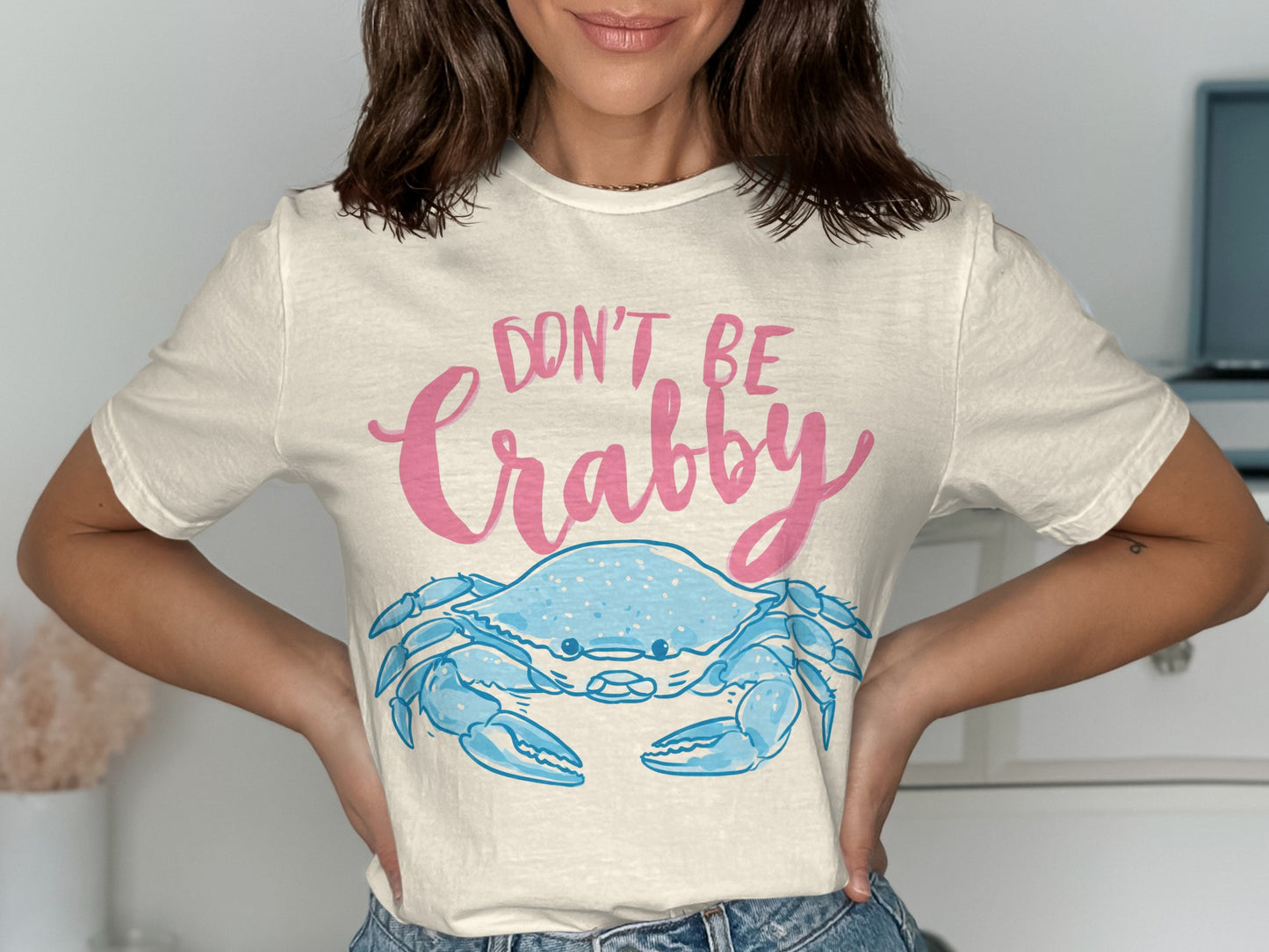 Cream t-shirt with blue crab graphic and "Don't Be Crabby" text.