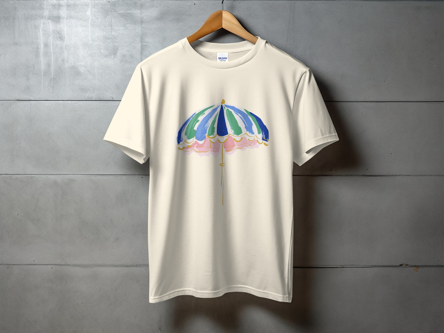 Cream t-shirt with watercolor umbrella design.