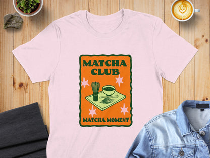 Pink t-shirt with "Matcha Club" and "Matcha Moment" text and matcha tea graphic.