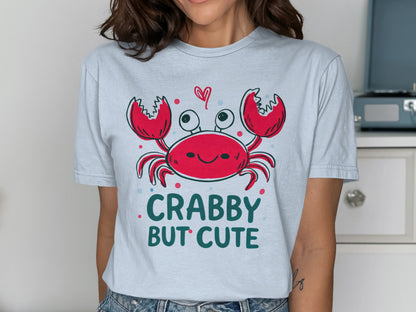 Crabby but cute cartoon crab with hearts on a light blue t-shirt.
