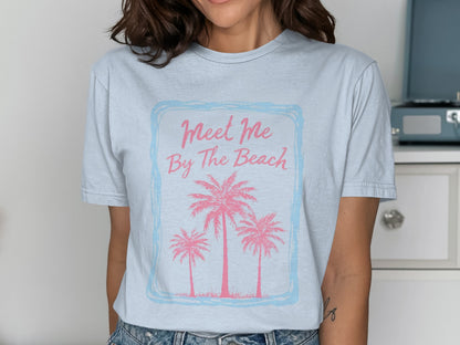 Light blue t-shirt with pink palm trees and "Meet Me By The Beach" text.