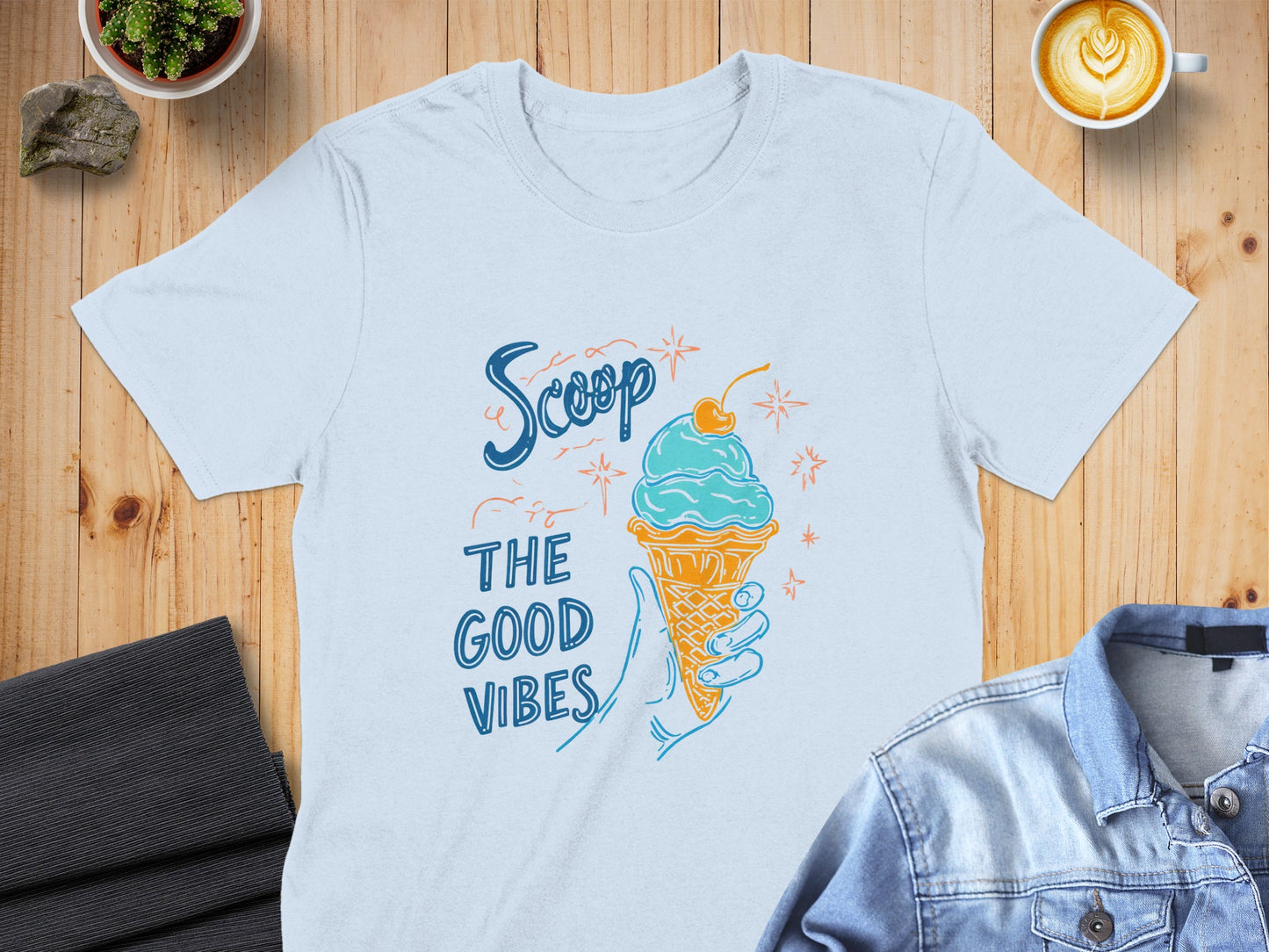Light blue t-shirt with ice cream cone and "Scoop the good vibes" text.