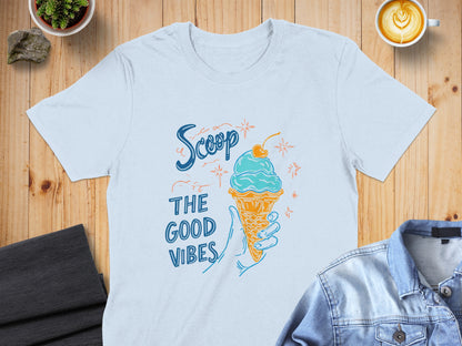 Light blue t-shirt with ice cream cone and "Scoop the good vibes" text.