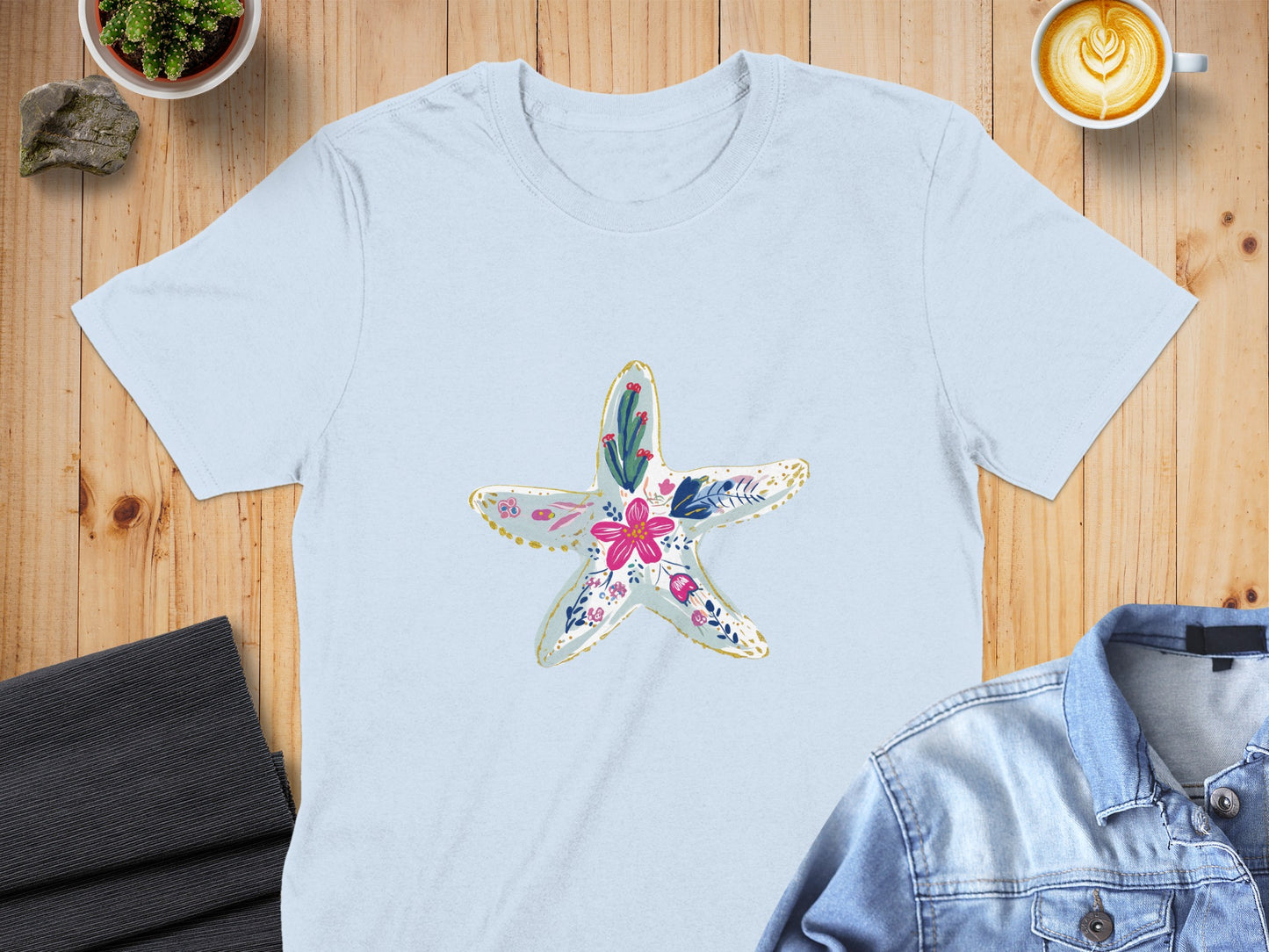 Light blue t-shirt with a floral starfish graphic.